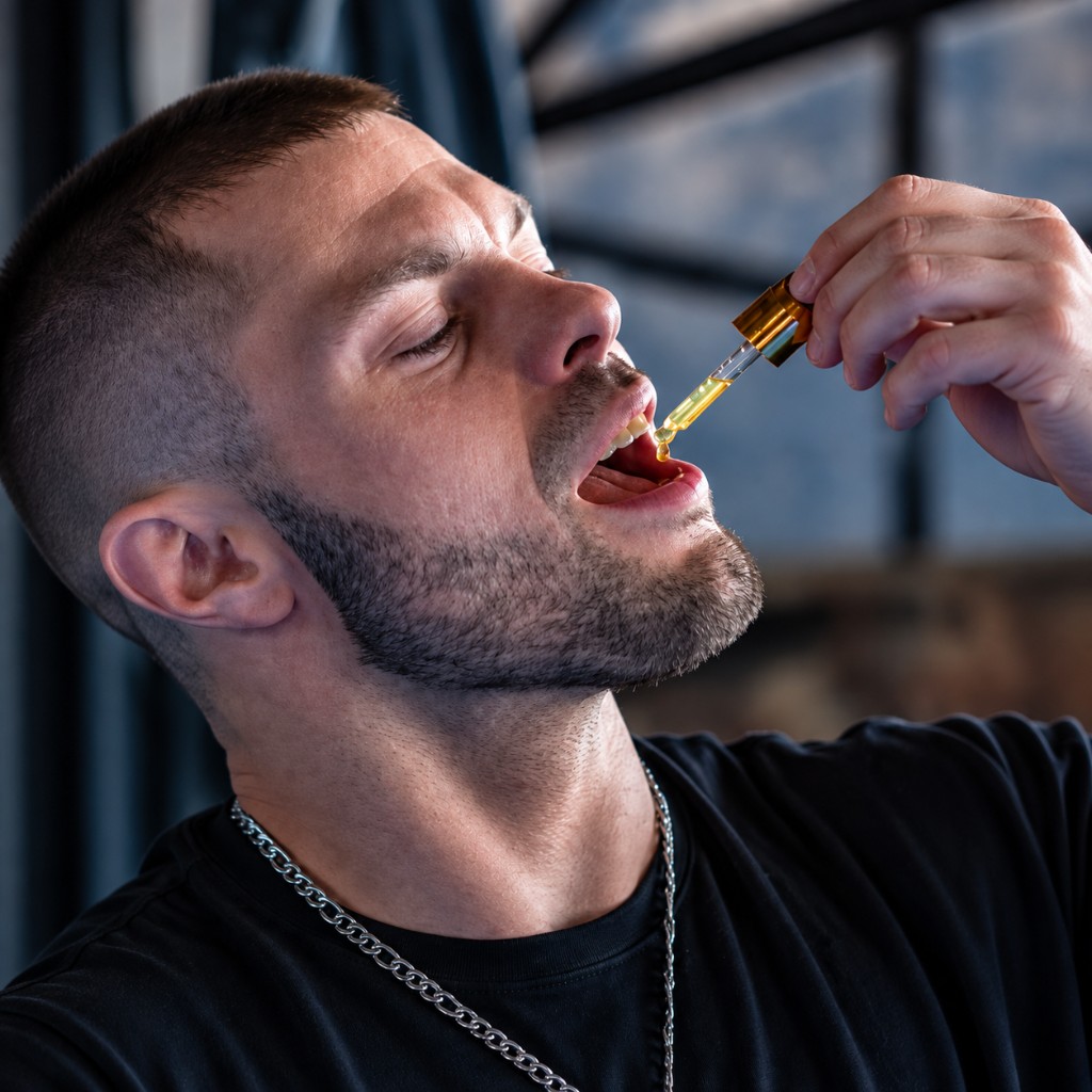 Man taking Xperience Youth Liquid drops